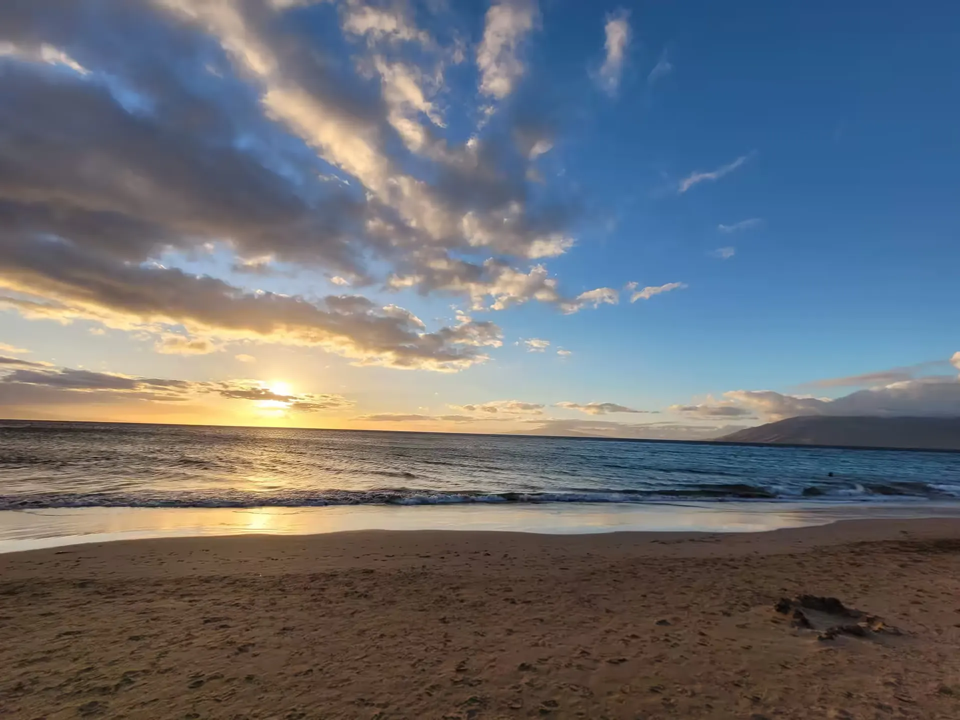 Sunset sky over the ocean and shoreline in Maui